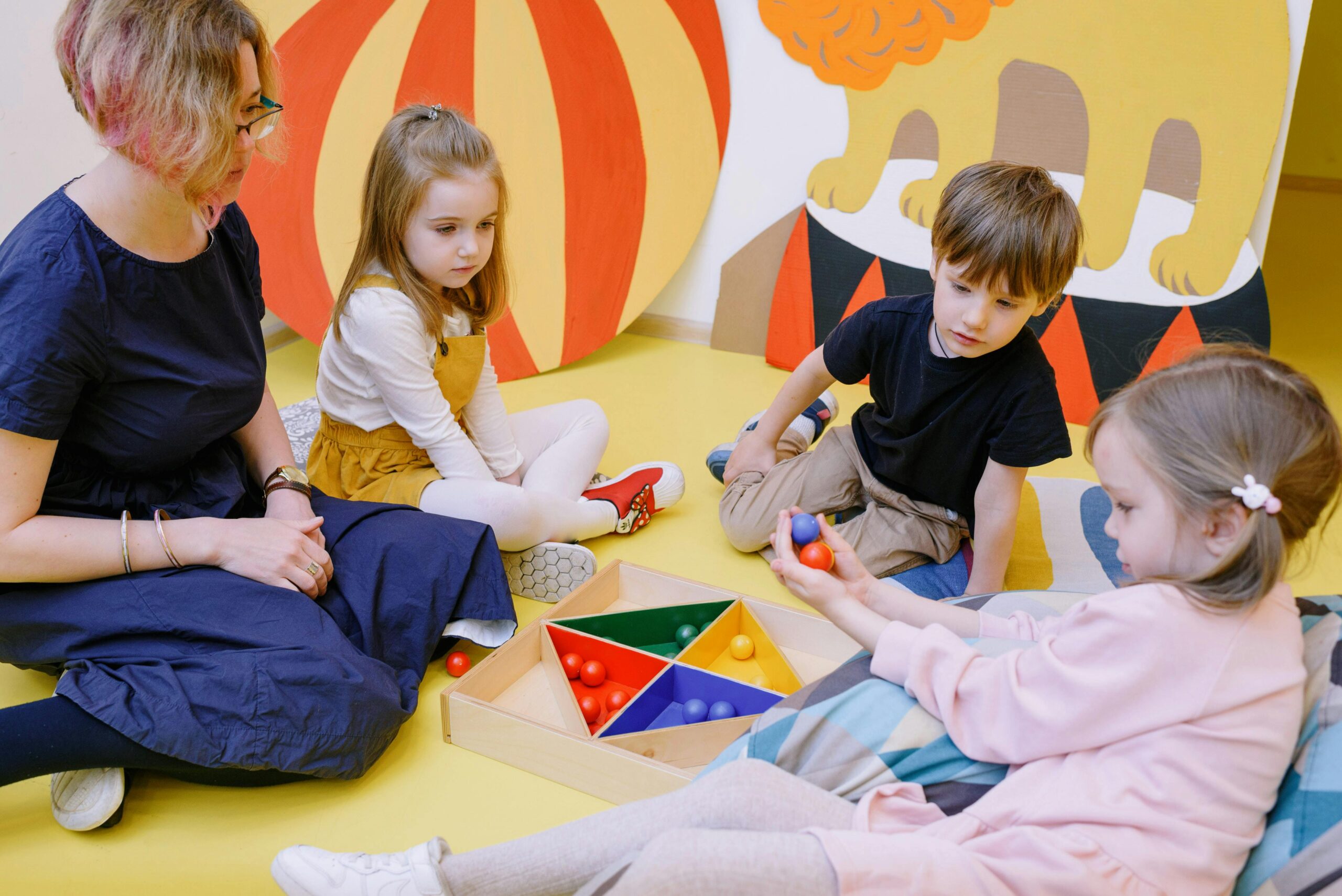 Children playing and learning with a teacher in a vibrant preschool setting.